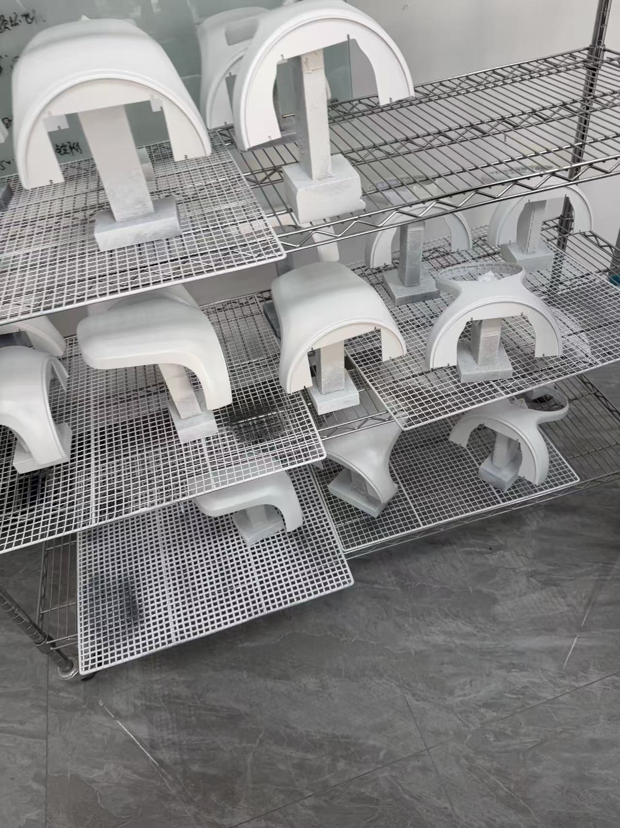 Coated metal components positioned on racks in the Zhenling surface finishing work area